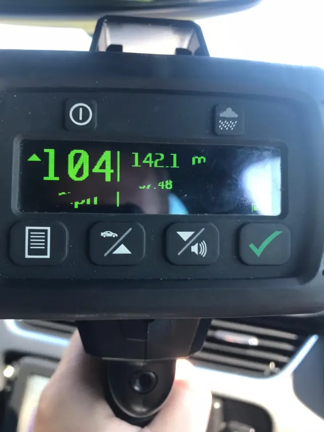 A speed gun showing a 104mph reading