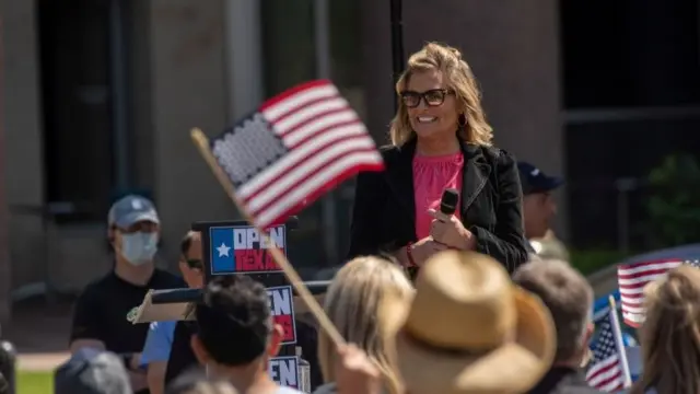 Shelley Luther, owner of a Dallas hair salon, speaks to supporters at an "Open Texas" rally against coronavirus restrictions outside of City Hall in Frisco, Texas, April 25, 2020