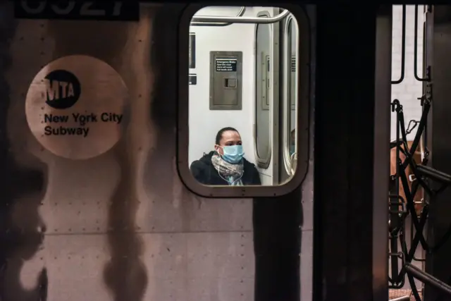 Person wears mask on New York City metro