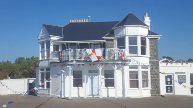House with Guernsey and Union flags and bunting