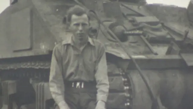 Laurie Burn in front of a tank