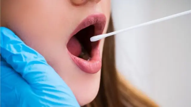 Swab sample being taken from woman