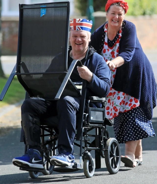 A man and woman move a chair in Redcar