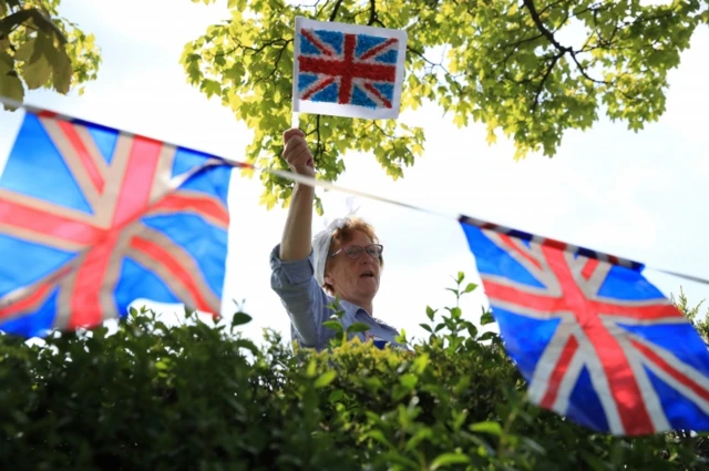 Sheila Gaffney waving to friends from her garden