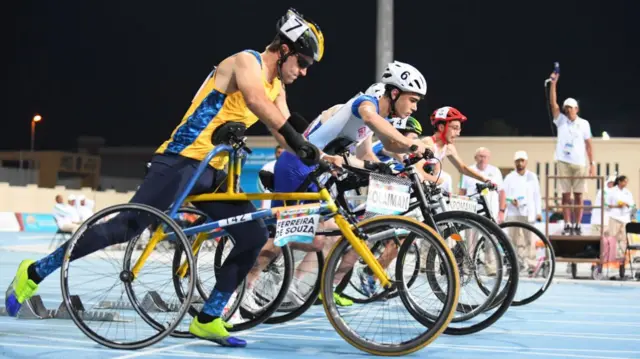Athletes line up for the 100m RR3 final at the World Para Athletics Championships