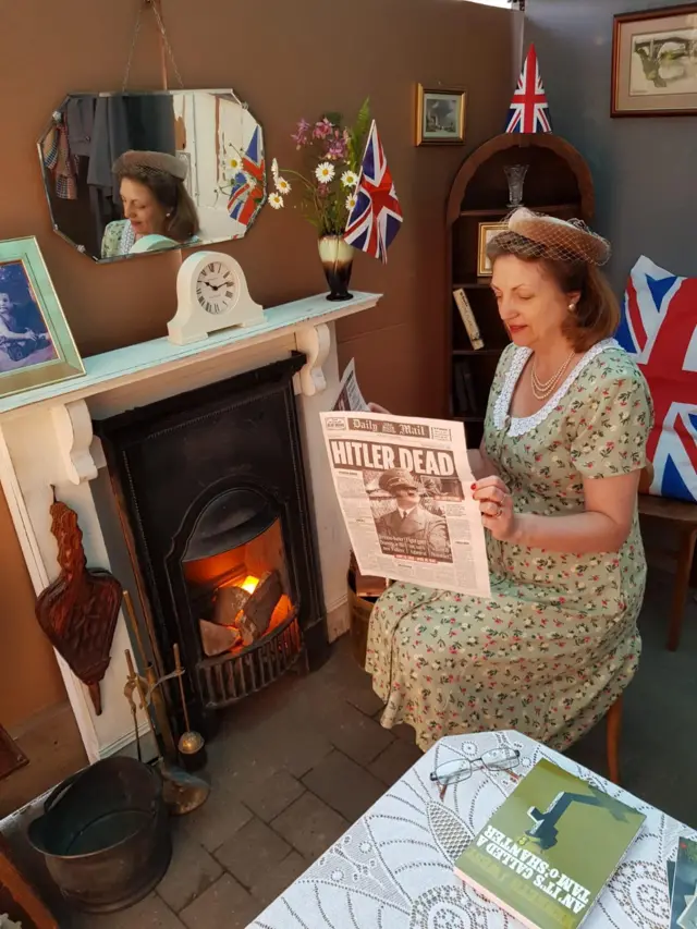 Lynn Westwood reading a 1945 newspaper