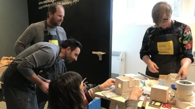 people making sculptures on table