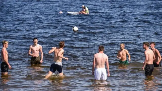 Young men playing in water