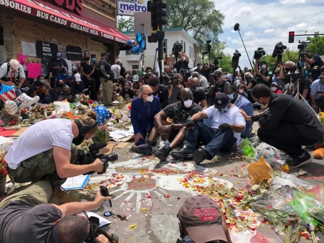 Terrence Floyd leads a prayer vigil at his brother's memorial site