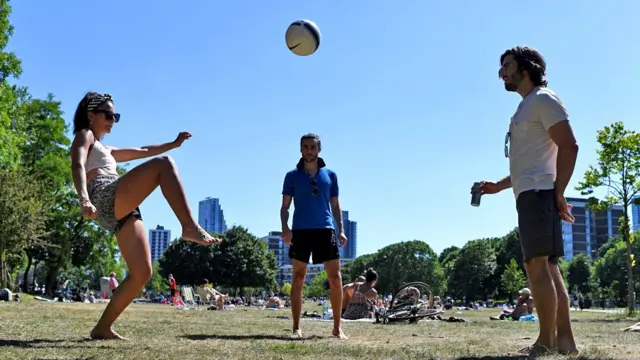 People having a kickabout in the park