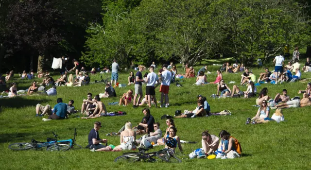 Young people sunbathe in Glasgow's Kelvingrove Park