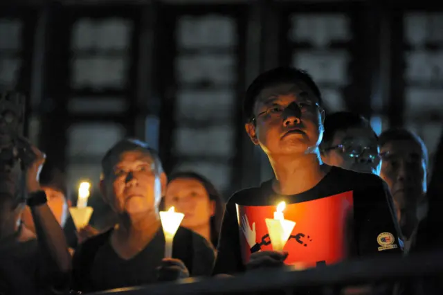 People hold candles as they take part in a candlelight vigil at Victoria Park on June 4, 2019 in Hong Kong, China