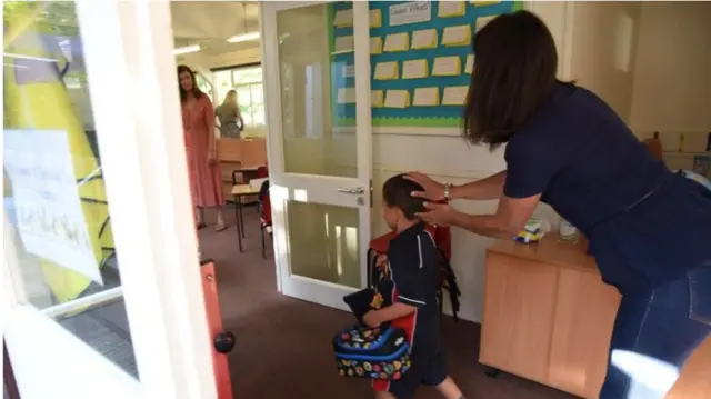 Mother sends child into classroom