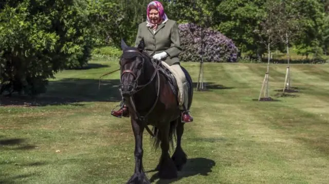 The Queen riding a horse