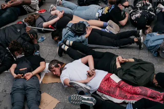 Protesters in Times Square have staged a "die-in" as they lie with their hands behind their backs like George Floyd