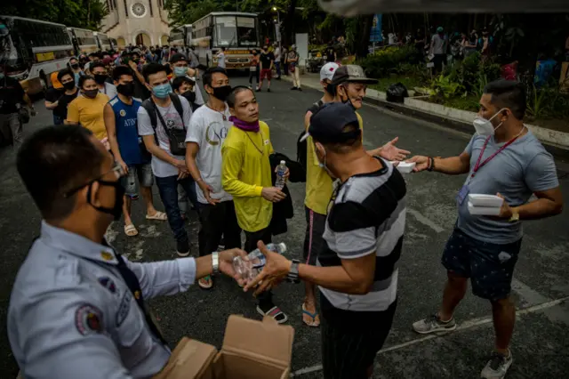 Filipinos out of work and stranded due to the coronavirus pandemic queue to receive meals