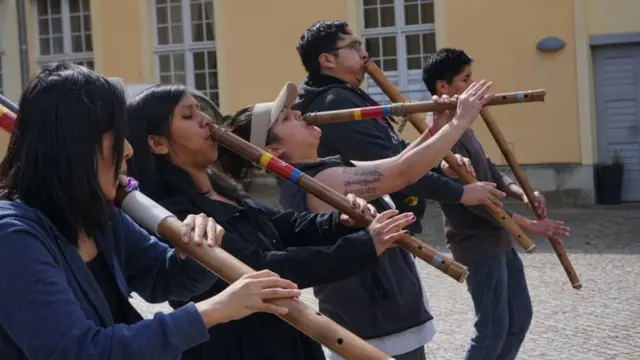 Members of the orchestra play panpipes