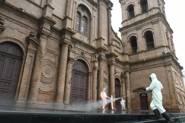 Local workers clean in front of Metropolitan Cathedral as a preventive measure, due the coronavirus disease (COVID-19) outbreak, in Santa Cruz, Bolivia March 26, 2020.