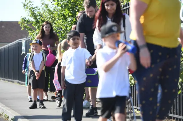 Parents drop off children at Queen's Hill Primary School in Norfolk