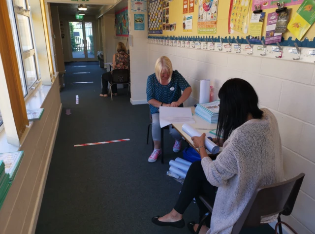 Teachers working in a corridor