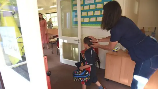 Mother dropping off son at school