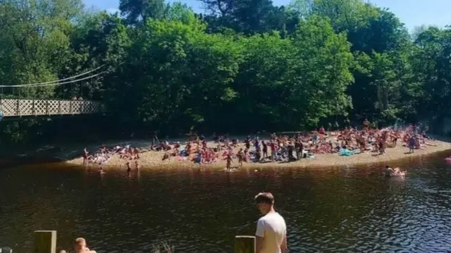 Crowds gathered by the River Wharfe in Ilkley