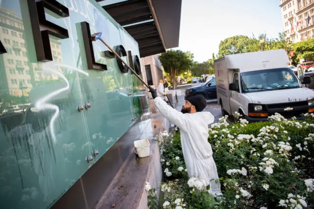 A worker cleans graffiti from the headquarters of the AFL-CIO union, the largest union in the US