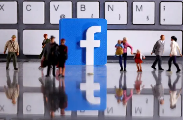 Facebook logo with small toy people figures