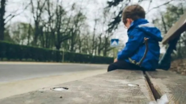 Child sat on a bench (generic)