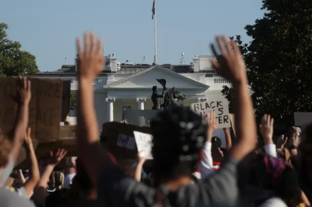 Protesters, with the White House in the background