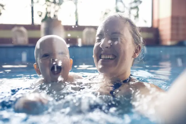 Mother and baby in swimming pool