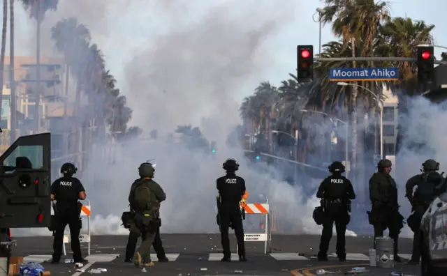 Police watch as tear gas is deployed during demonstrations in the aftermath of George Floyds death on May 31, 2020 in Santa Monica, California.