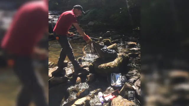 Ranger collects rubbish in North York Moors National Park