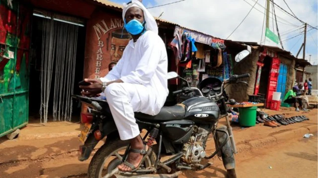 Man with a face mask on a motorbike