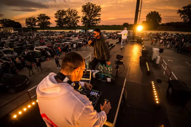 A member of Kontrafakt band performs on stage during a drive-in hip hop concert on 5 June 2020