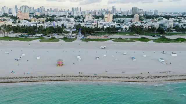 An aerial drone view as beachgoers take advantage of the opening of South Beach on June 10, 2020 in Miami Beach, Florida