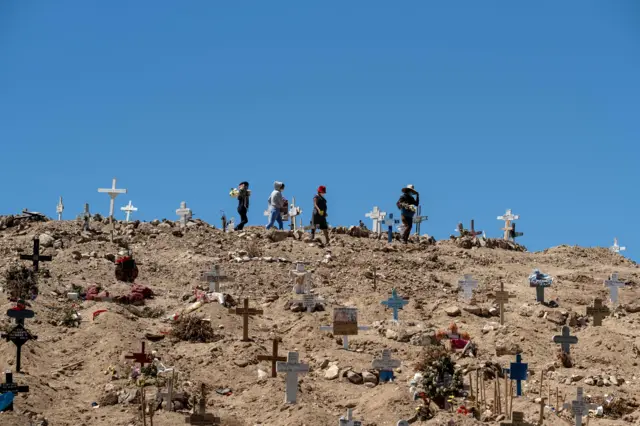 Locals visit the graves of their relatives at the municipal cemetery #13 in Tijuana, Baja California state, Mexico on 9 June 2020