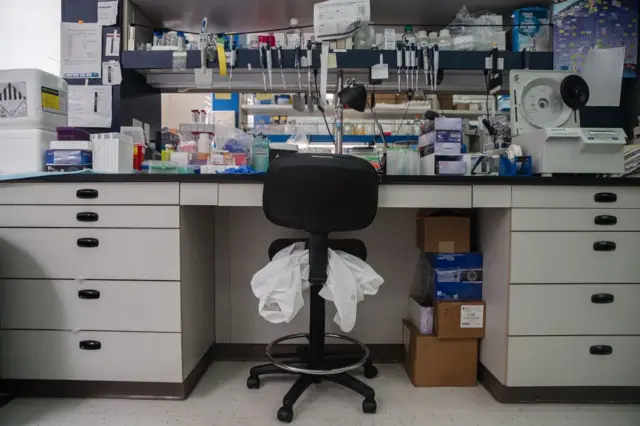 A lab coat is seen on a chair at a workstation in the lab at Sorrento Therapeutics in San Diego, California on May 22, 2020