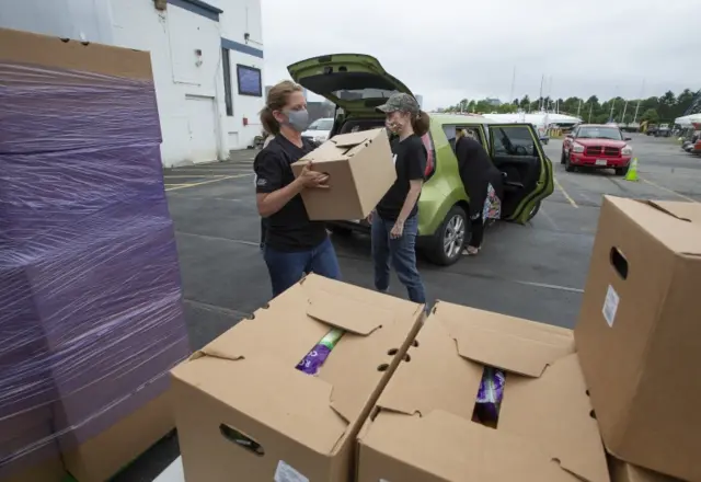 Kelly Gifford (L) and Kris Wilton (R) load provisions in Boston. 11 June 2020