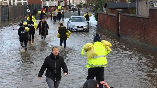 People moving sandbags