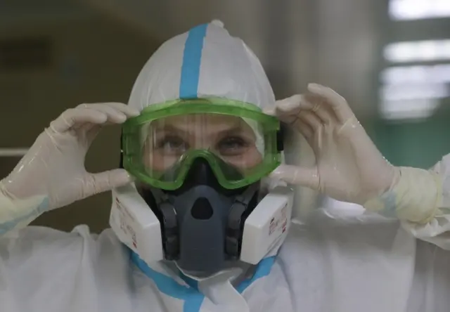 A nurse adjusts her goggles in an intensive care unit in Moscow's hospital