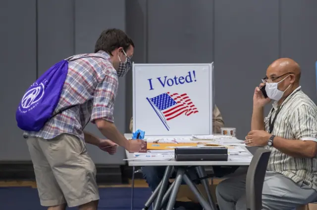 A voter casts their ballot at Dekalb County"s Decatur Recreation Department precinct in the coronavirus-delayed Georgia presidential preference primary election