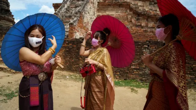 Three women wearing face masks