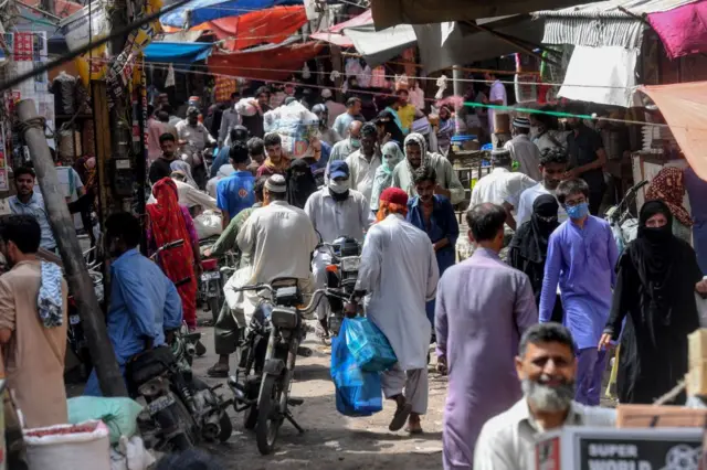 Residents at a crowded market in Pakistan on 10 June