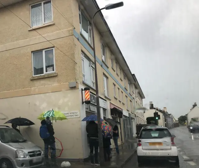 Queues outside Jim's barber at Five Oaks in Jersey