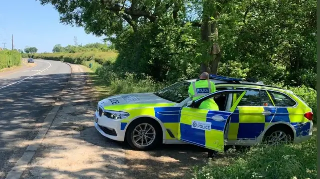 Police officer recording speed of drivers