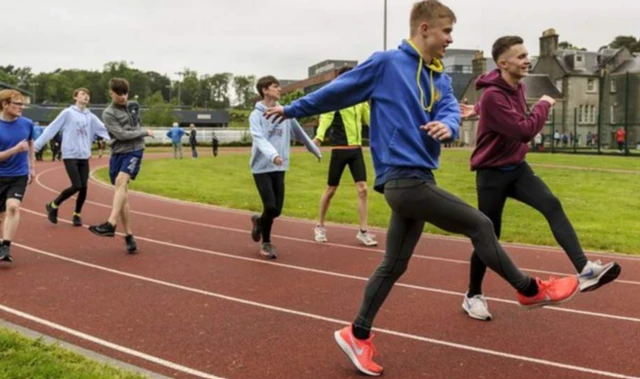 Young athletes train on a track