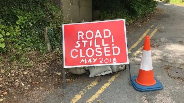 Road sign in the village with graffiti