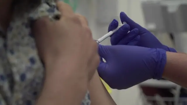 A woman getting a vaccination