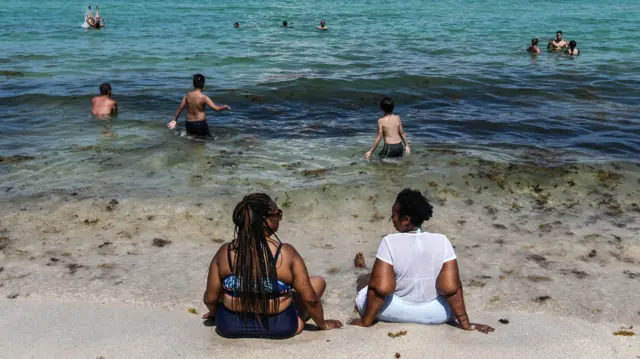 Beach-goers in Miami on 10 June